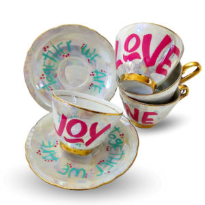 Vintage hand-painted tea cup and saucer set with a mother-of-pearl effect, perfect for collectors and enthusiasts